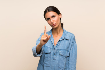 Young woman over isolated background frustrated and pointing to the front