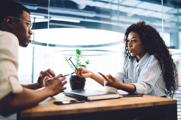 Black couple talking while sitting in cafe