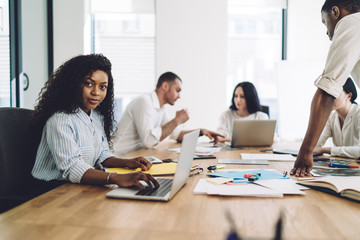 Professional female employee working with laptop