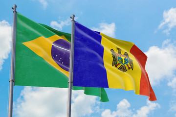 Moldova and Brazil flags waving in the wind against white cloudy blue sky together. Diplomacy concept, international relations.