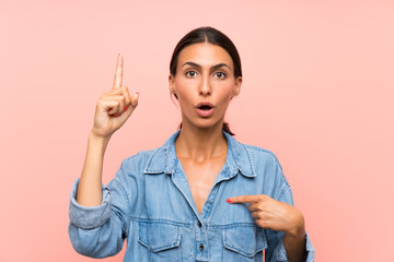 Young woman over isolated pink background with surprise facial expression