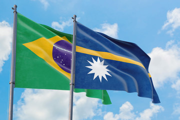 Nauru and Brazil flags waving in the wind against white cloudy blue sky together. Diplomacy concept, international relations.