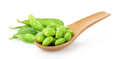 green soybeans in wood spoon isolated on white