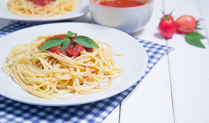 Spaghetti pasta with and tomato sauce on wood background