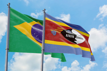 Swaziland and Brazil flags waving in the wind against white cloudy blue sky together. Diplomacy concept, international relations.