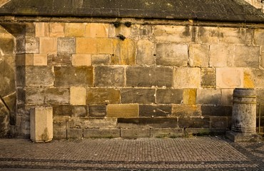 Stone wall background with black and yellow stones (Prague, Czech Republic, Europe)