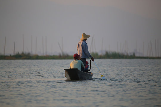 The famous fishermen of Inle Lake, Myanma, working at sunrise - Powered by Adobe