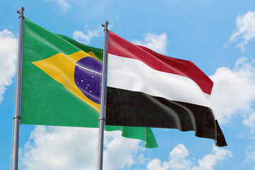 Yemen and Brazil flags waving in the wind against white cloudy blue sky together. Diplomacy concept, international relations.
