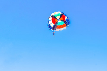 Parasailing behind sunset at Windmill viewpoints, Delight of people from parasailing flight - incredible impressions of the freedom of soaring and amazing view ,parasail view in indian Beach