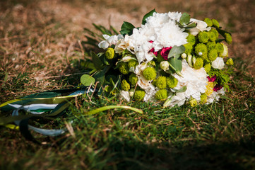 Bouquet of white flowers lying on the grass