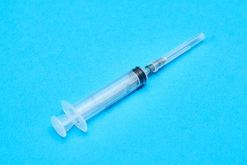 medical syringe on a blue background.