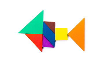 Color wood tangram puzzle in fish shape on white background