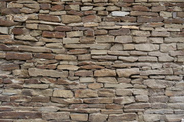 Stone wall. Texture of evenly laid stones.