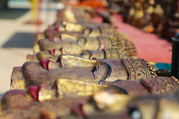 A lot of bright souvenirs on the counter of the ancient souvenir market in Myanmar