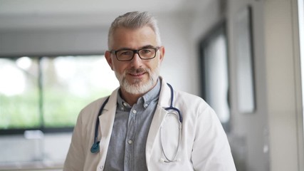 Portrait of mature doctor with eyeglasses - Powered by Adobe