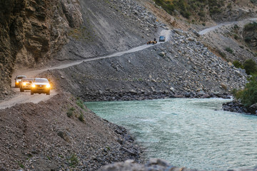 Off-road cars riding mountain serpentine in the Pamir mountains