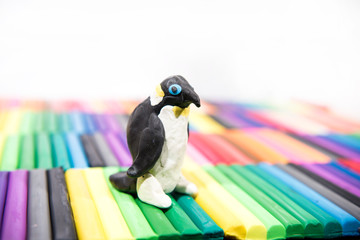 Play clay Animals. Penguin on colored background.