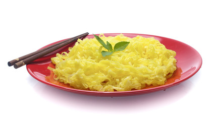 yellow noodles on dish isolated on white background