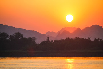 Beautiful sunset in the mountains with reflection on the river