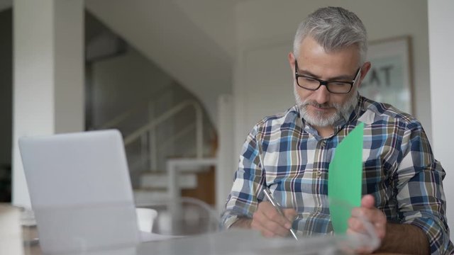 Man working from home on laptop computer