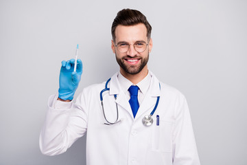 Close-up portrait of his he nice attractive cheerful cheery experienced confident qualified bearded doc paramedic preparing prick vaccine isolated on light white gray pastel color background