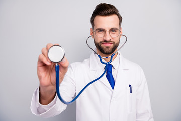 Close-up portrait of nice attractive cheerful kind bearded doc listening your breathing heart beat first aid help assistance patient visit isolated on light white gray pastel color background