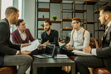 useful collaboration of successful business partners gathered in modern boardroom for holding conference, developing and discussing strategies and plans for future work