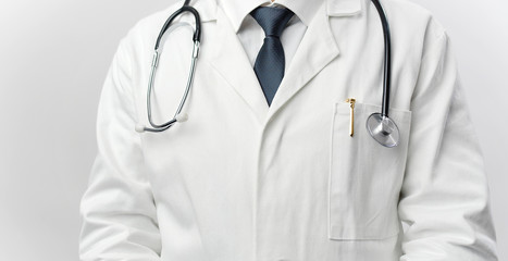 Cropped picture of male doctor wearing white coat, stethoscope, pen, and tie, front view