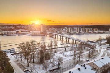 Aerial view of Joensuu, Finland in the morning in the first frost. In the foreground is the park and the Pielisjoki River. Bridge over the river. Penttila district in the background.