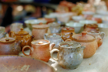 Beautiful clay teapots and mugs, fired ceramics.