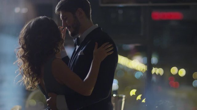 Young man and woman dancing in the evening