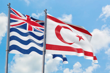 Northern Cyprus and British Indian Ocean Territory flags waving in the wind against white cloudy blue sky together. Diplomacy concept, international relations.
