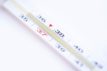 Close-up medical mercury thermometer on the white background.