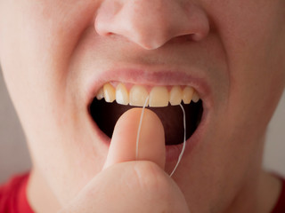 Dental flossing. Morning oral hygiene. Teeth cleaning.