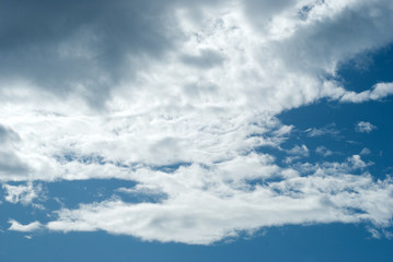 Blue sky with picturesque, white and gray clouds