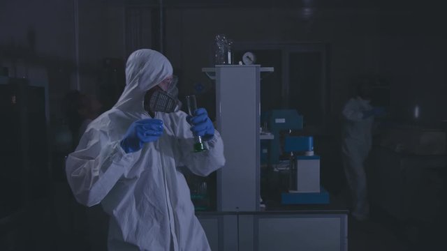 Accident in scientific laboratory. Employees leaving lab in hurry.
