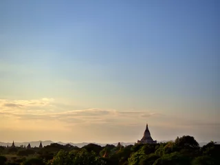 Fotobehang The evening landscape of Bagan, the World Heritage site of Myanmar with clear golden sky © Paphinvich