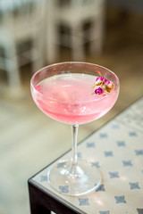 Pink Rose Sparkle Cocktail in the Bar, Blurred Background