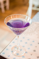 Modern Sparkle Violet Cocktail in the Bar, Blurred Background