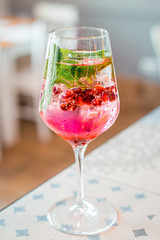 Pink Rose Pomegranate Cocktail in the Bar, Blurred Background