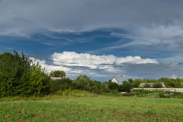 Obraz premium Beautiful summer rural landscape with cloudy sky