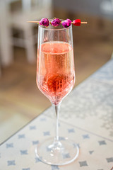 Pink Rose Sparkle Cocktail in the Bar, Blurred Background