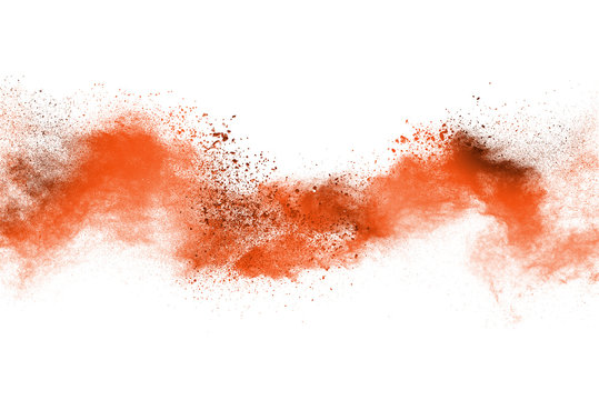 abstract orange powder splatted background. Colorful powder explosion on white background. Colored cloud. Colorful dust explode. Paint Holi.