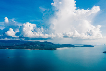 Fototapeta na wymiar Bird's eye view of picturesque uninhabited islands surrounded by pure nature. Beautiful blue sky with white clouds. Breathtaking scenery landscape with sea