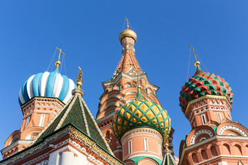 Fototapeta na wymiar Colorful domes of St. Basil's Cathedral on a background of blue sky. Moscow, Russia.