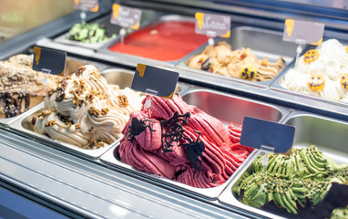 Selling delicious fresh ice cream by weight in a shop window, background