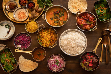 South Indian vegetarian dishes served in thali style on wooden table