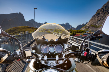 Biker rides on road in Norway. First-person view.