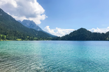 Huge blue lake in the background of the mountain peaks in Austria, Tyrol