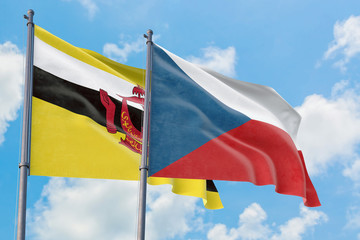 Czech Republic and Brunei flags waving in the wind against white cloudy blue sky together. Diplomacy concept, international relations.